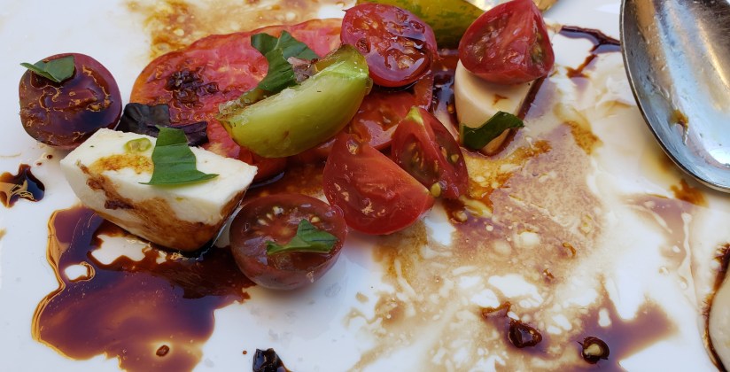 brightly colored heirloom tomatoes, fresh mozzarella cheese and balsamic vinegar