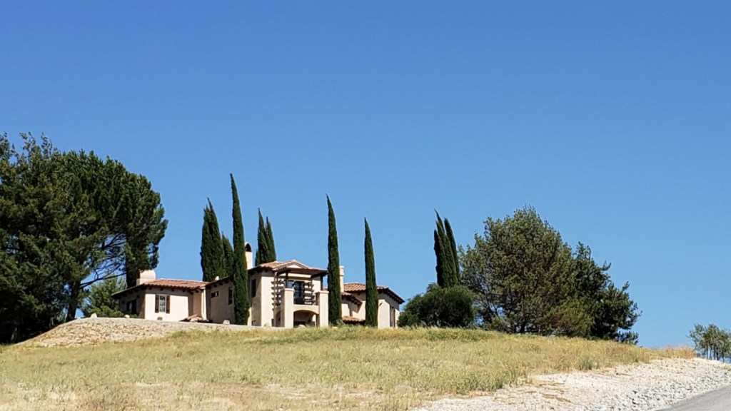 Villa on hilltop, surrounded by Italian cypress