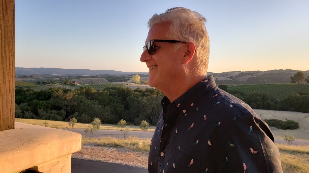 Greg laughs as he admires the sunset and the view