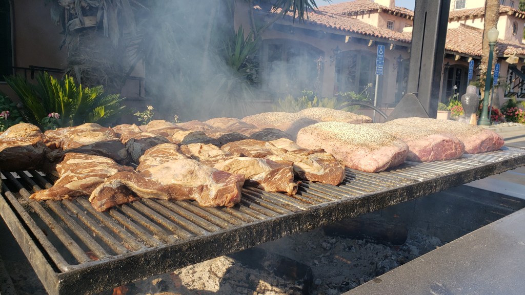 Huge grill topped with tri tip and racks of ribs