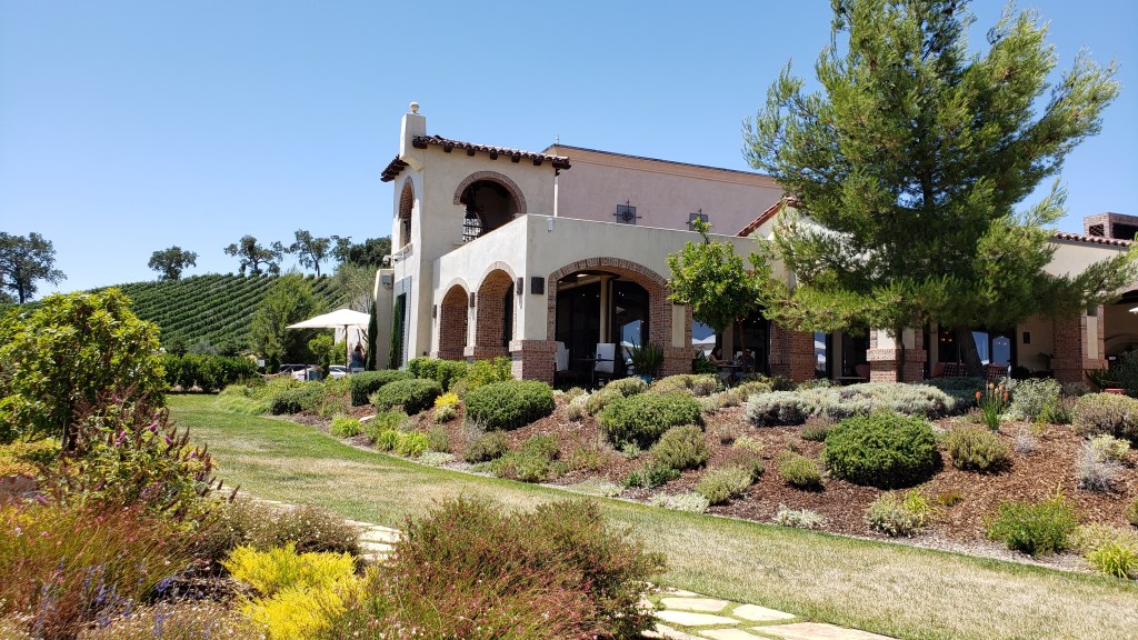 Winery building nestled among vineyards and gardens