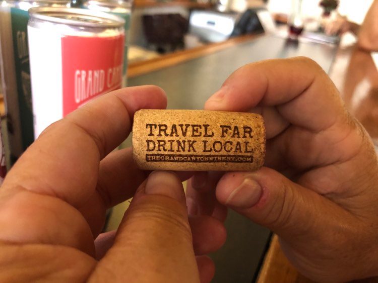wine cork with words travel far, drink local