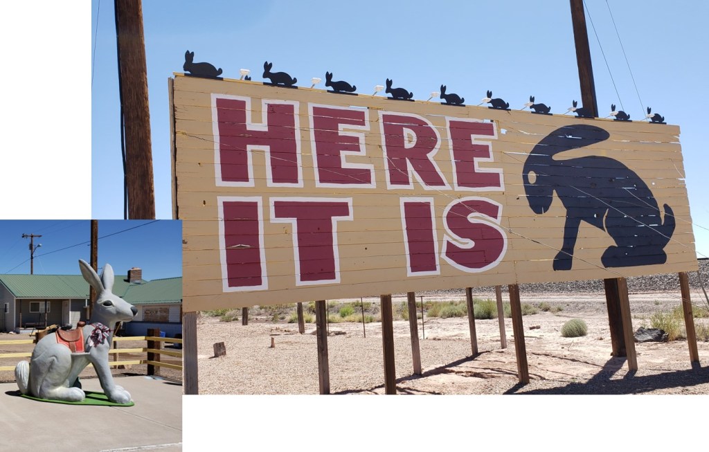Giant yellow sign with jackrabbit and Jackrabbit statue