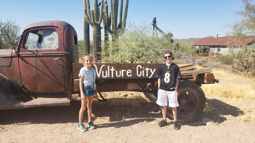 rusted out truck in front of ghost town