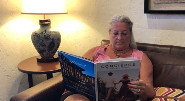 woman on couch reading book