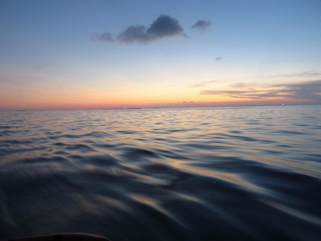 flat sea with colorful sunset on the horizon